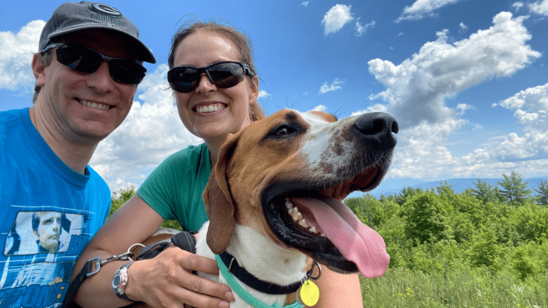 volunteers with dog in field
